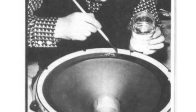 Photograph from Le Audiophile, Article page 68. Jean Hiraga is shown manually applying a damping compound to a loudspeaker cone.